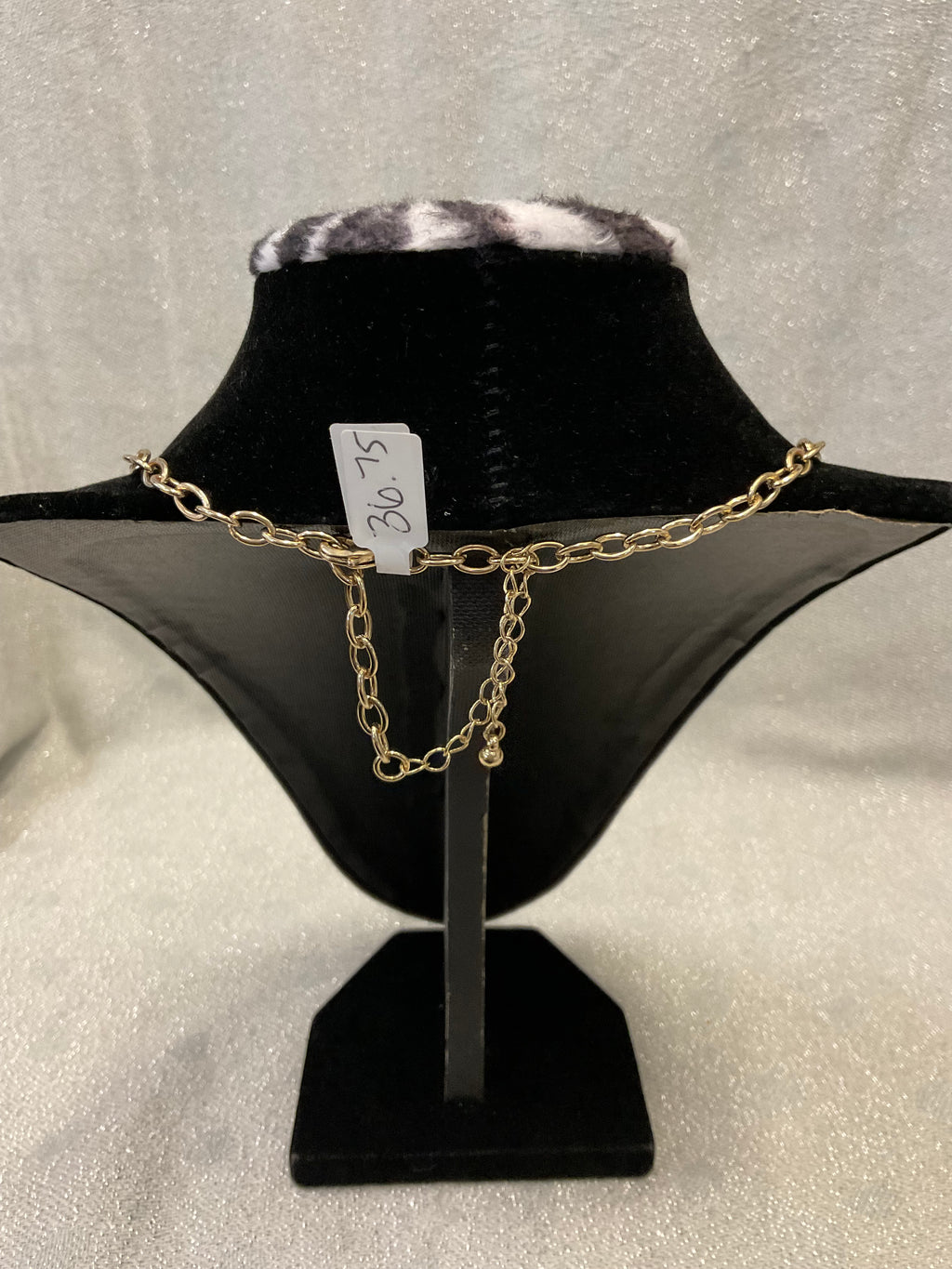 Gold toned fashion necklace with hammered leaf shaped pendants