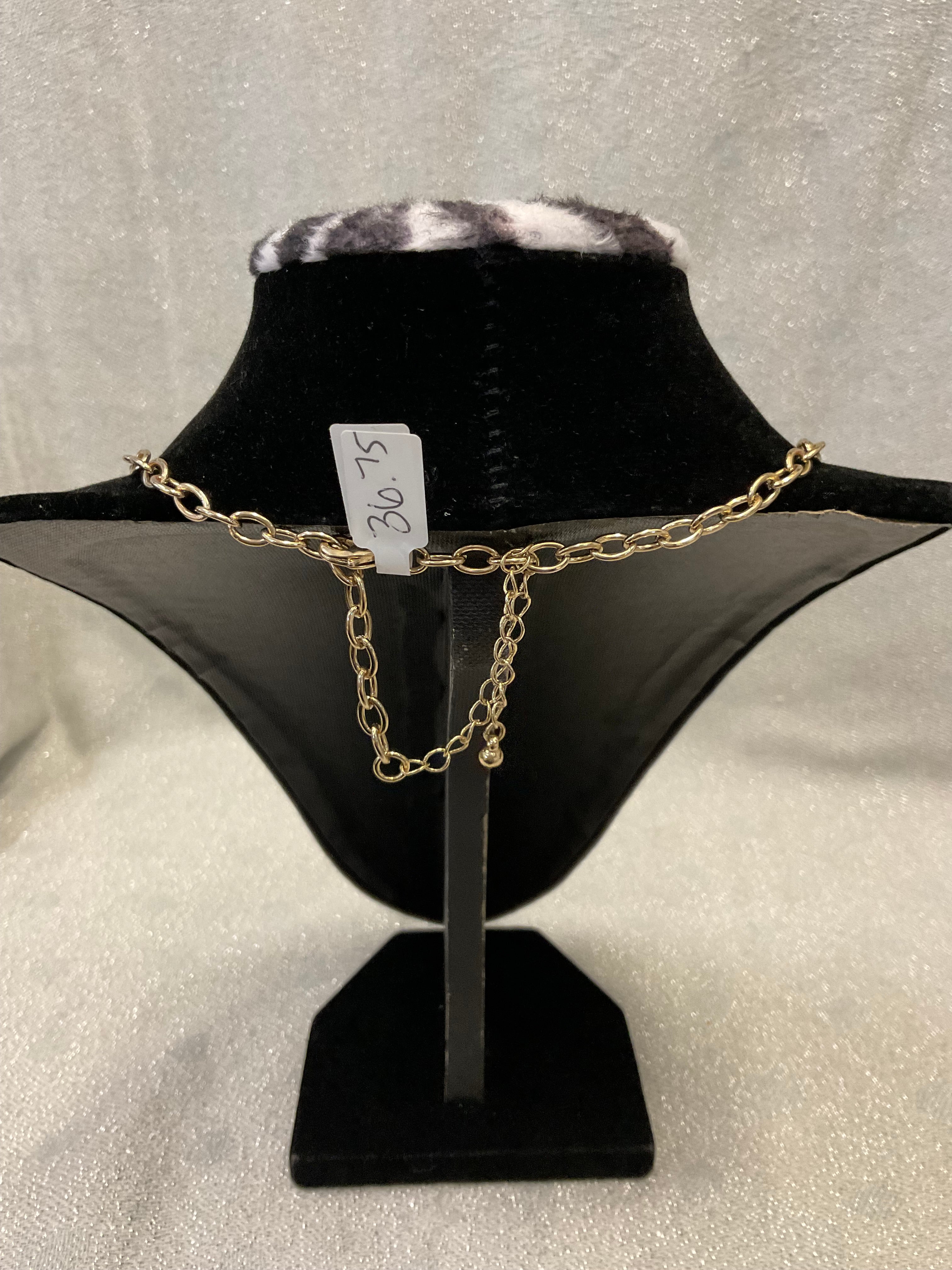 Gold toned fashion necklace with hammered leaf shaped pendants