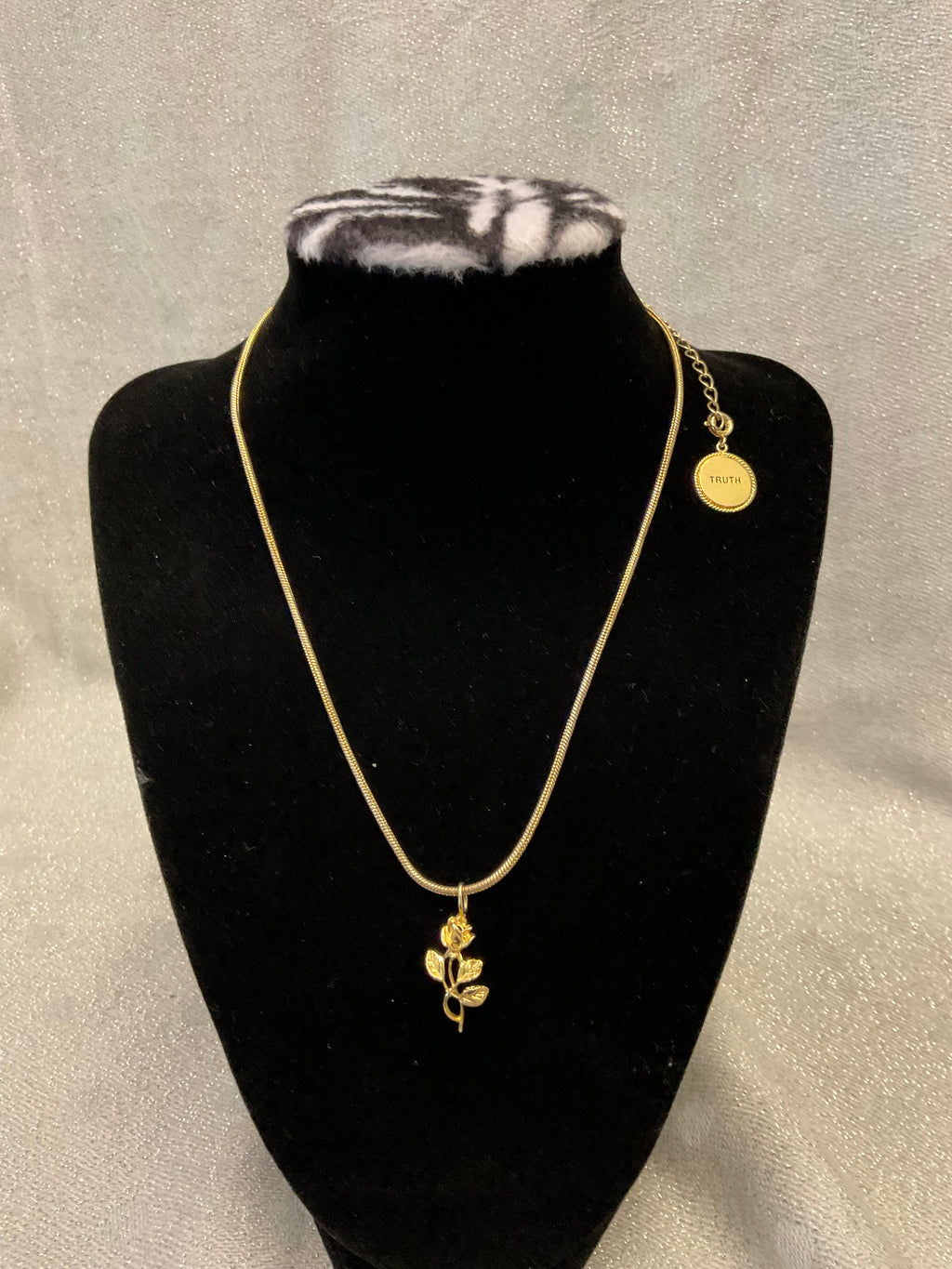 Gold tone necklace with rose pendant