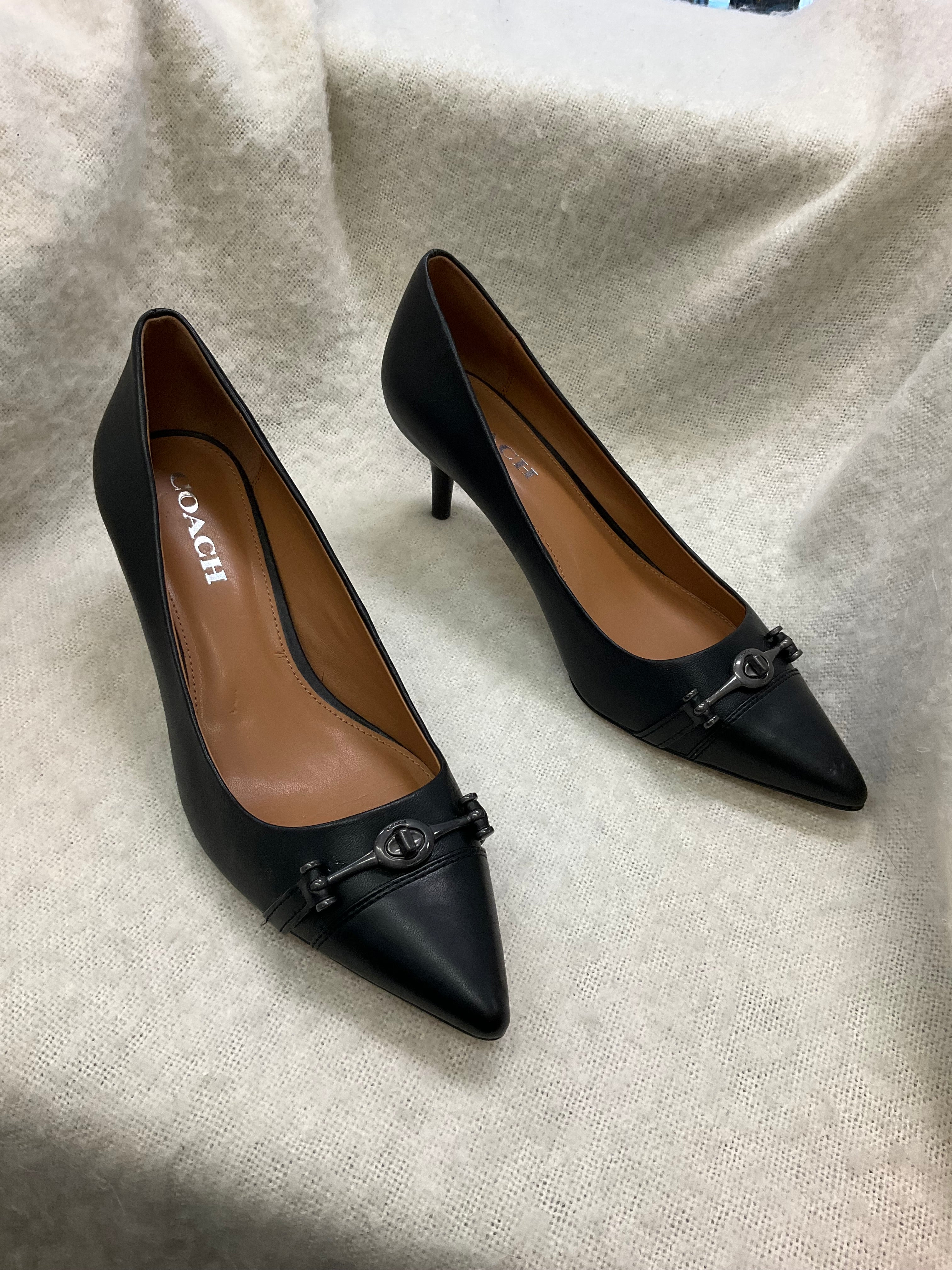 Coach Stylish black Coach pointed toe heels. Has silver-tone horsebit detail on front. Kitten heels. Size 10B.