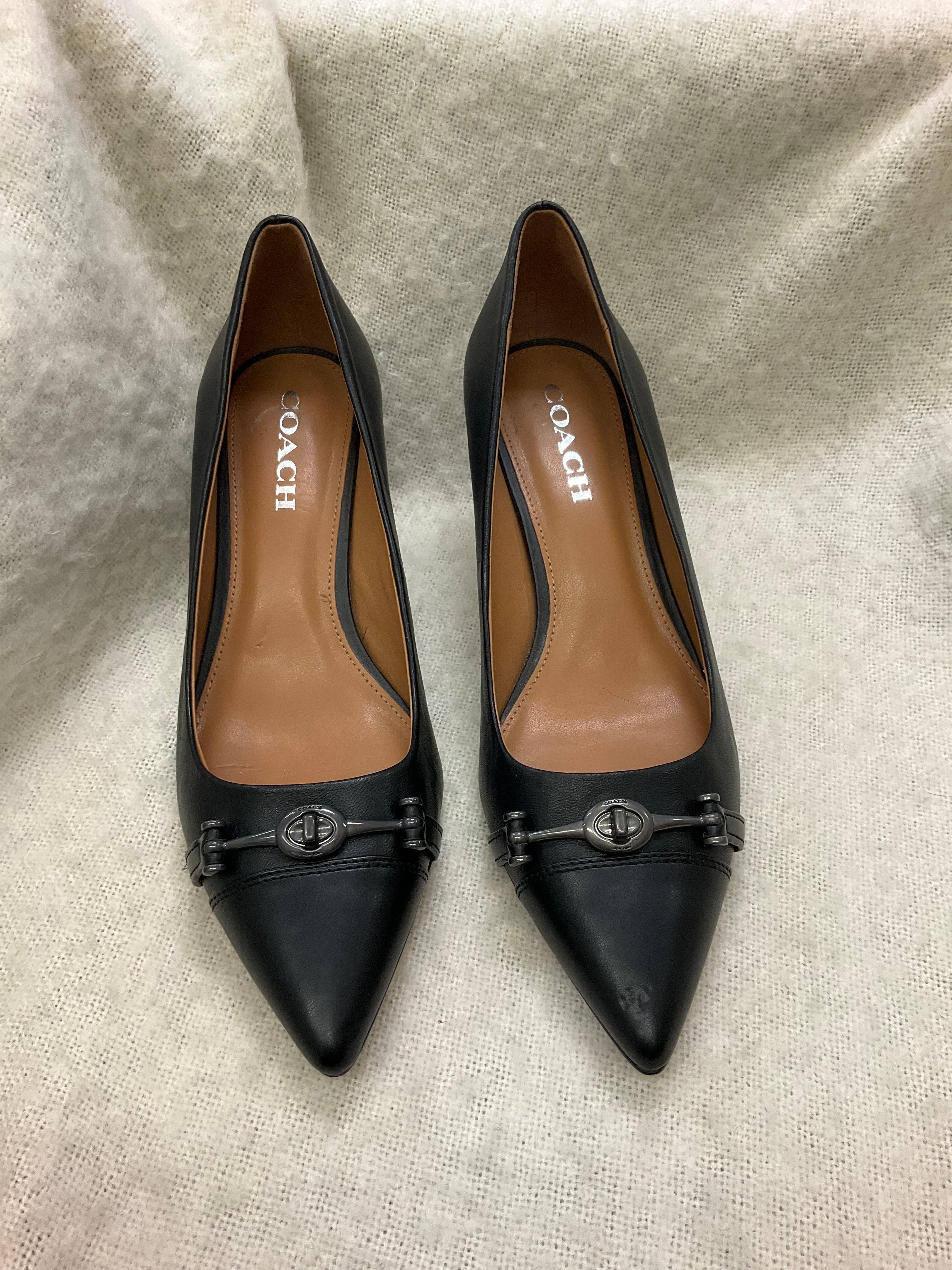Coach Stylish black Coach pointed toe heels. Has silver-tone horsebit detail on front. Kitten heels. Size 10B.