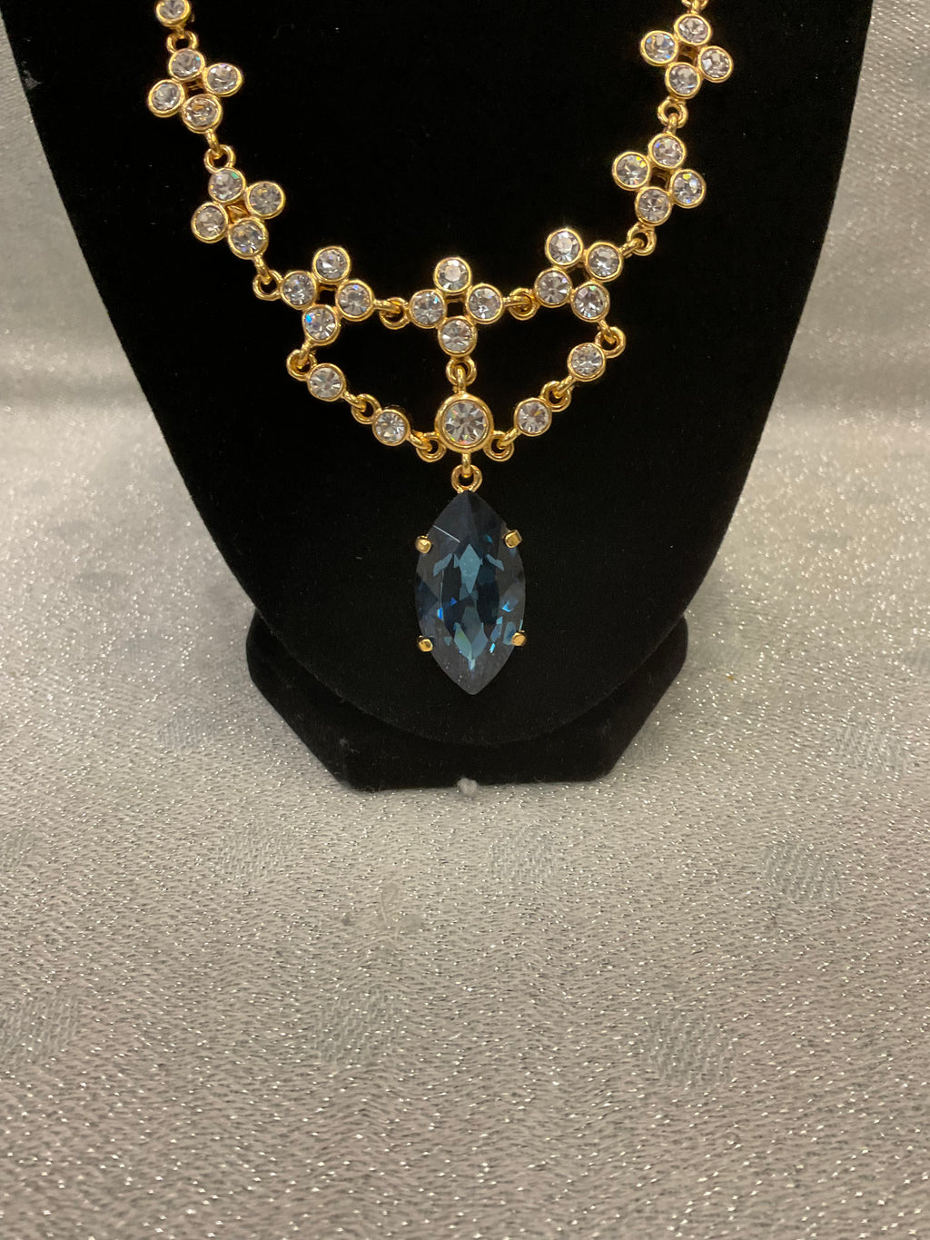 Vintage gold tone rhinestone necklace with large blue teardrop crystal pendant