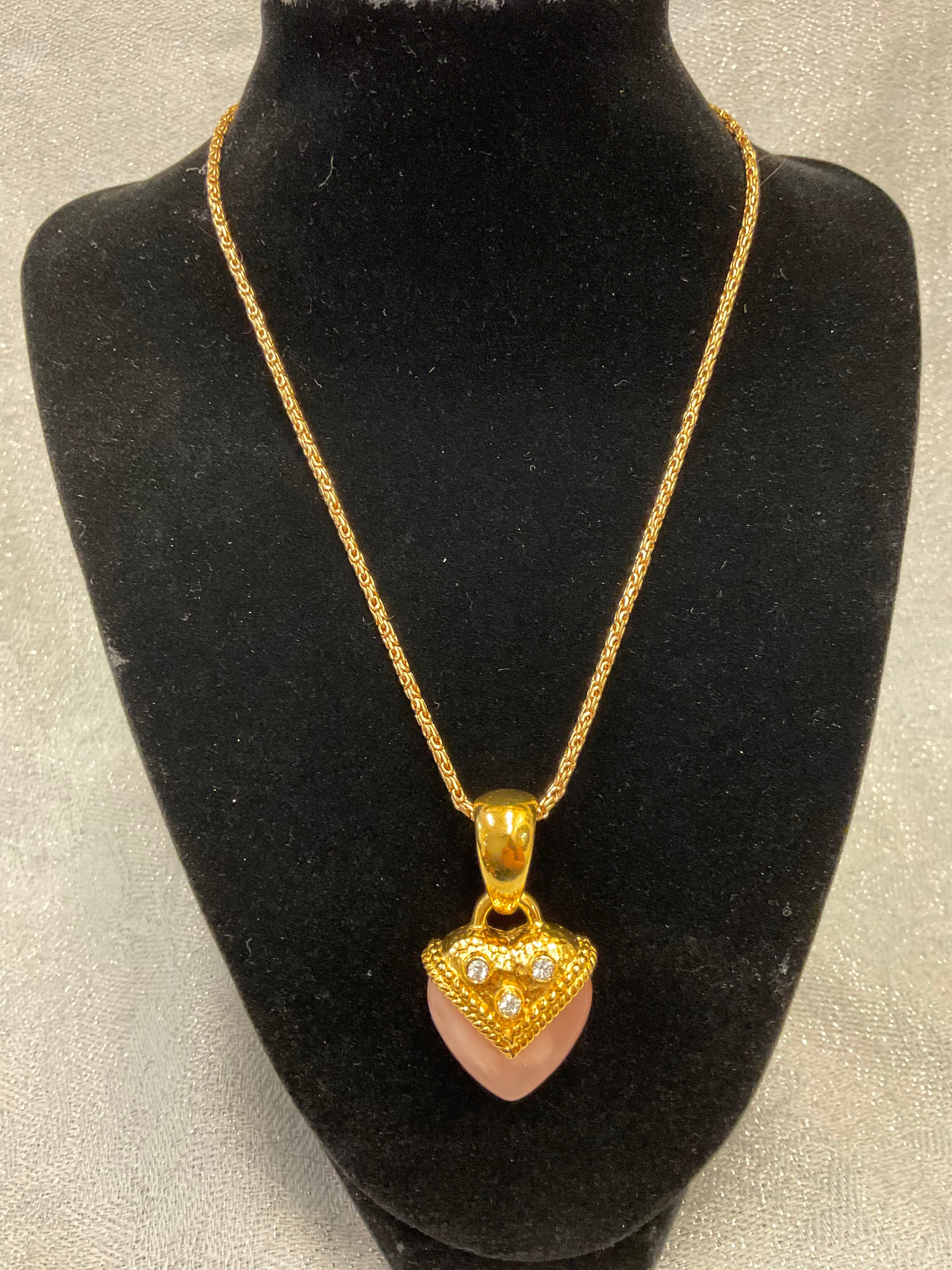 Vintage gold necklace with a pink heart pendant