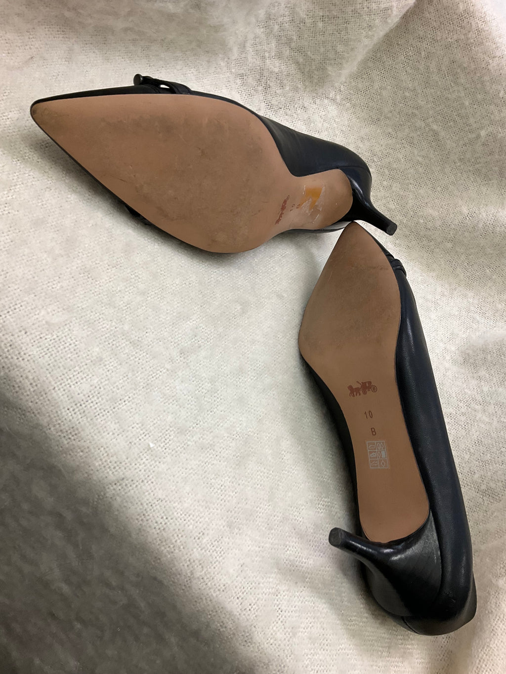 Coach Stylish black Coach pointed toe heels. Has silver-tone horsebit detail on front. Kitten heels. Size 10B.