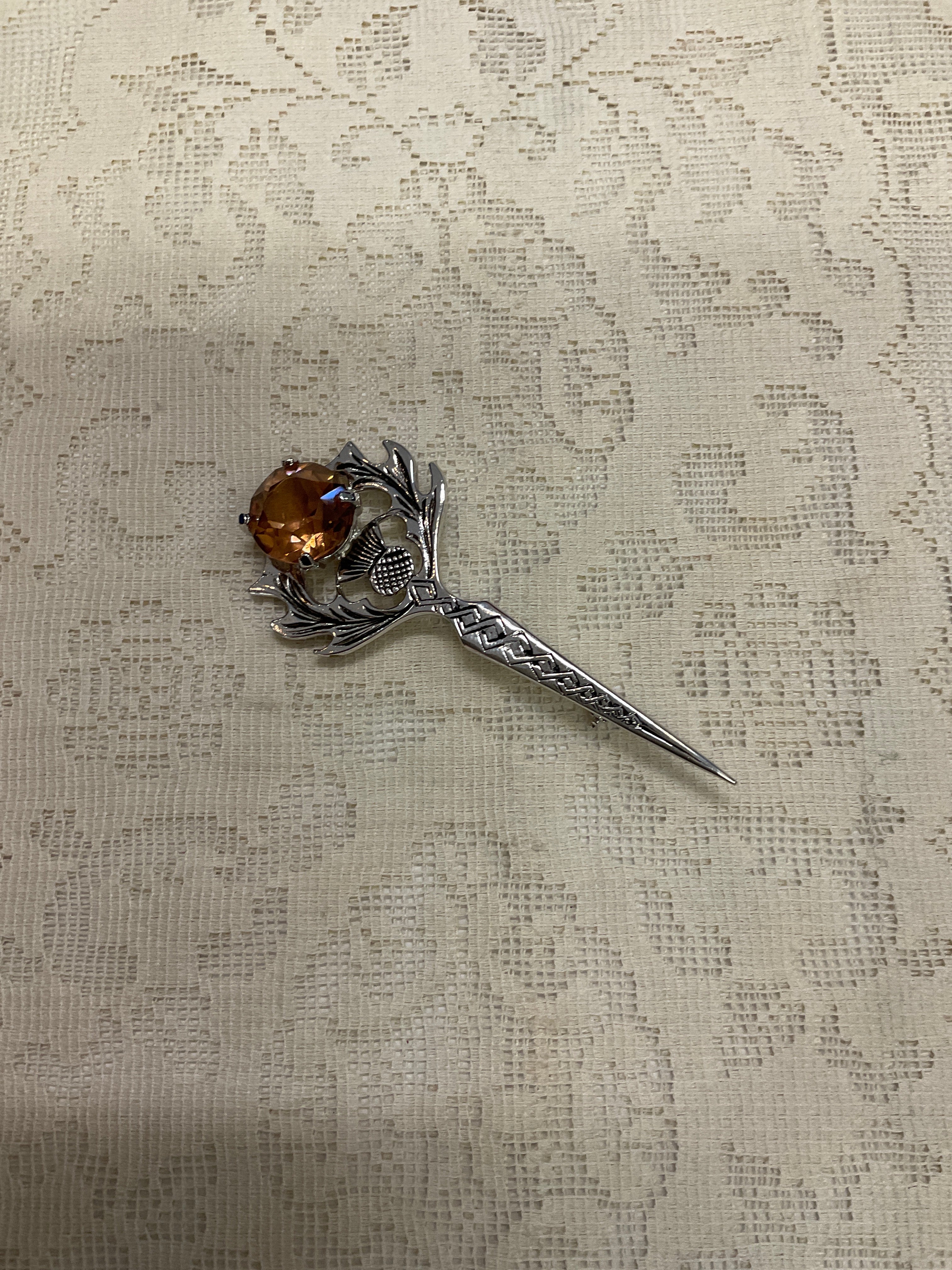 Sword like broach pin