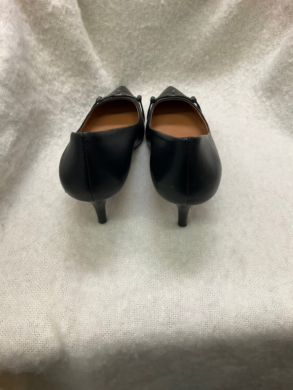 Coach Stylish black Coach pointed toe heels. Has silver-tone horsebit detail on front. Kitten heels. Size 10B.