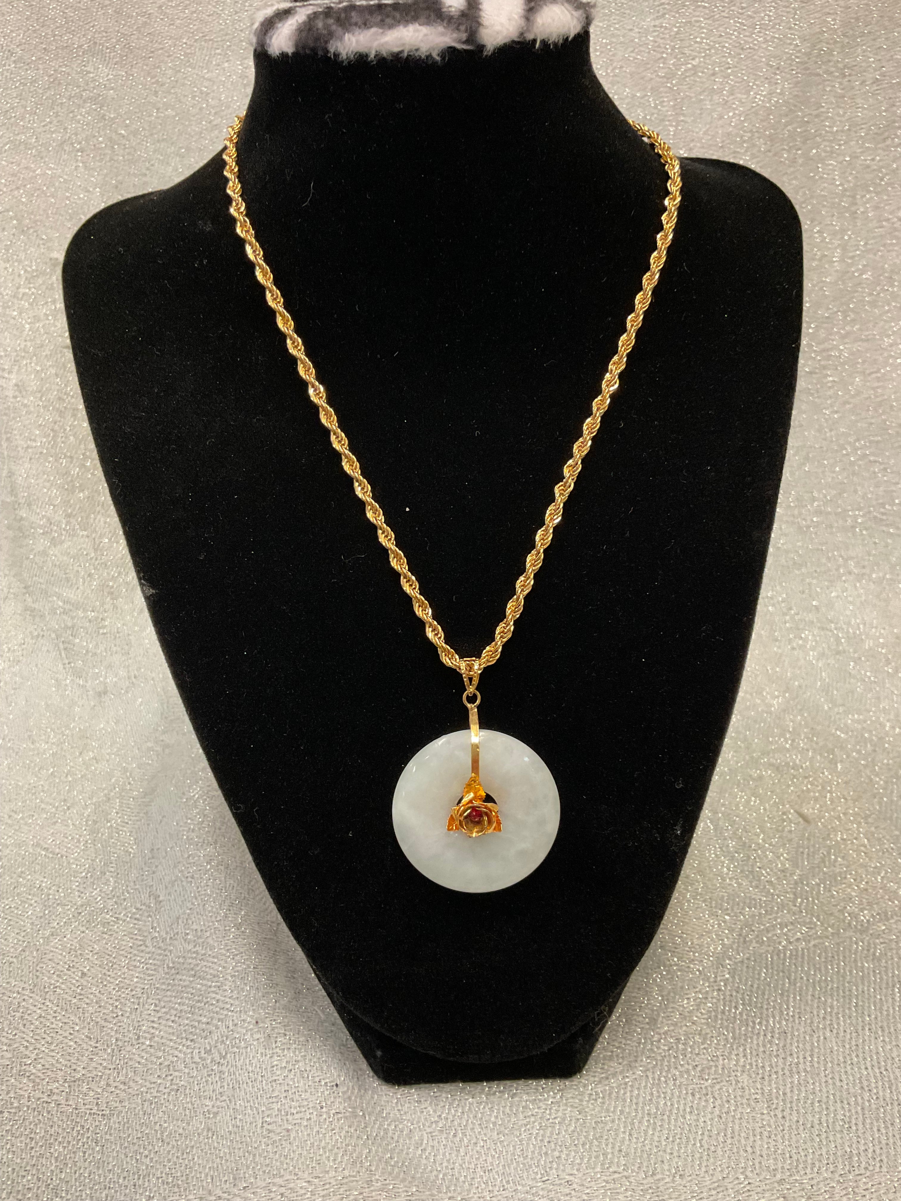 Gold tone rope chain necklace with white jade donut pendant
