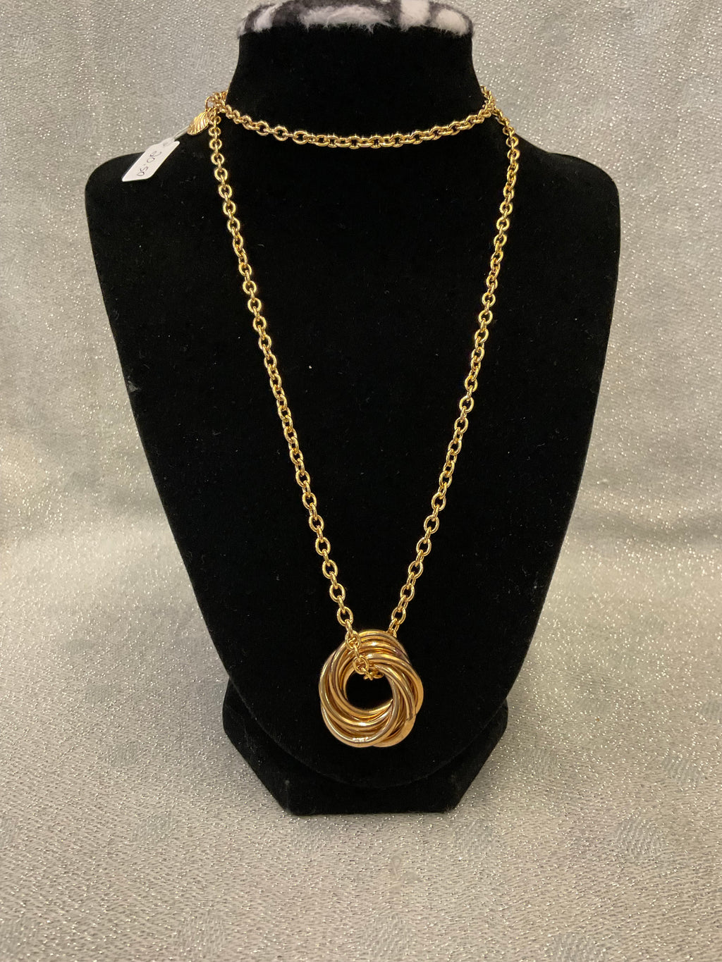 Gold tone long chain necklace with a multi ring pendant