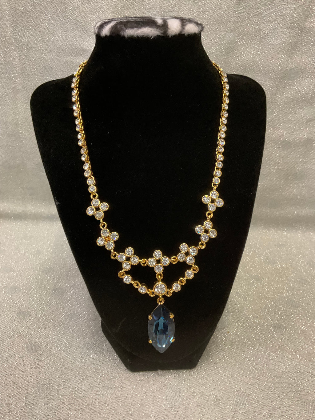 Vintage gold tone rhinestone necklace with large blue teardrop crystal pendant