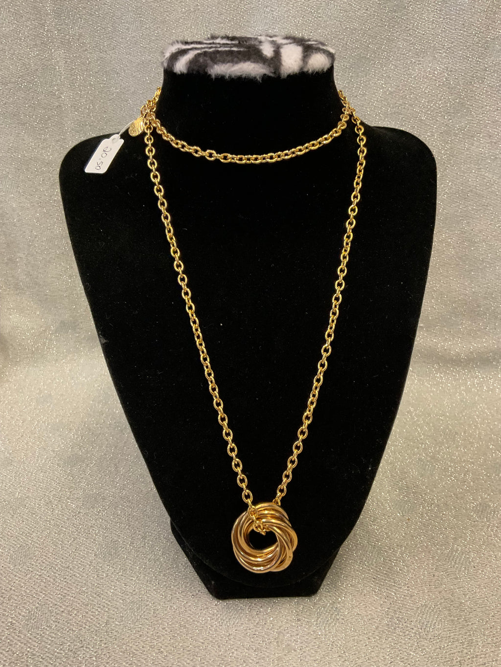 Gold tone long chain necklace with a multi ring pendant