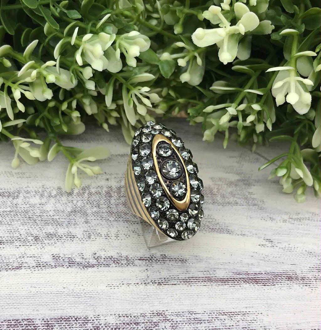 Vintage Akkad ring 6.5 gold toned elongated oval with rhinestones and grey enamel.