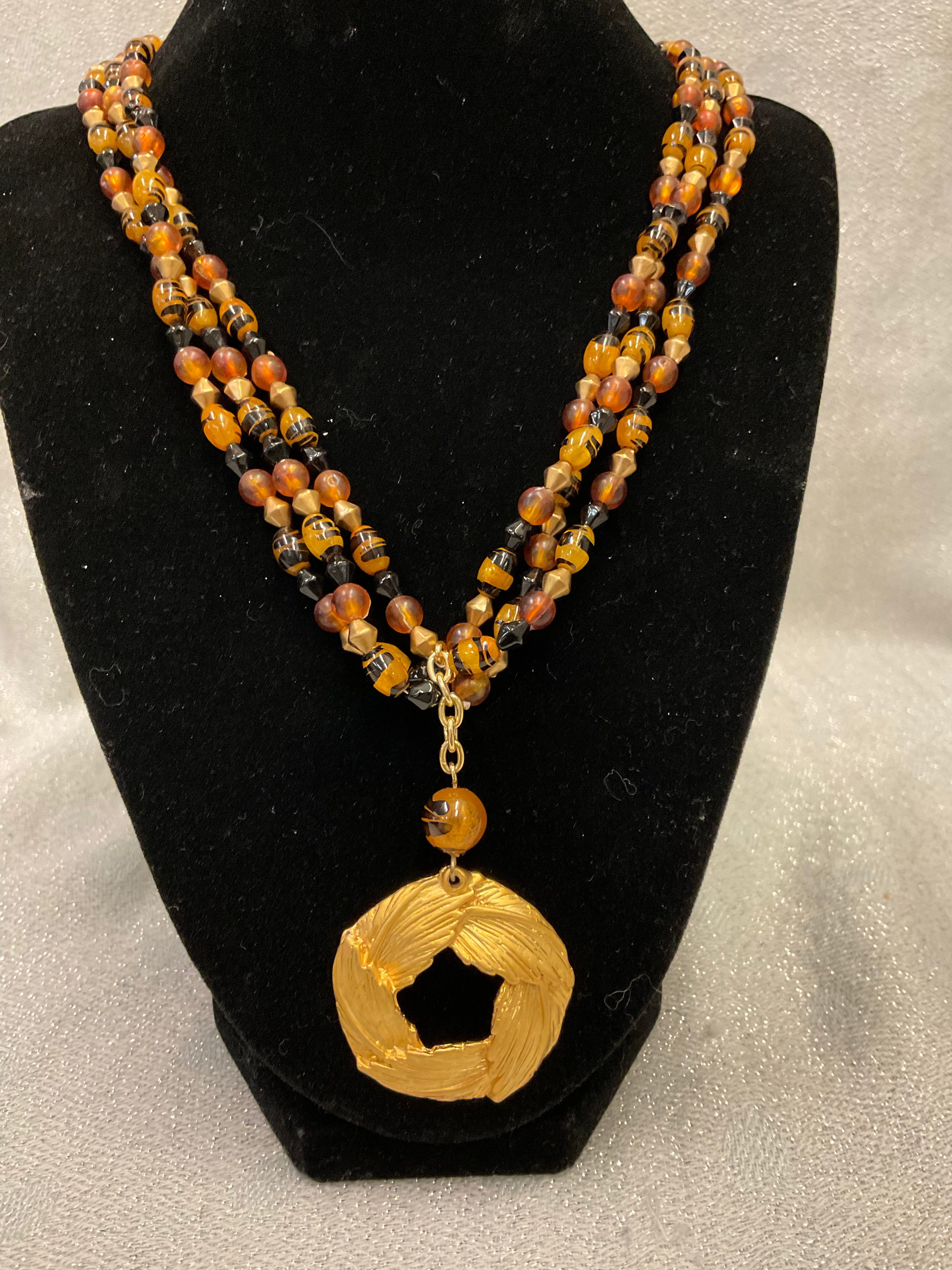 Gold beaded necklace with leaf pendent