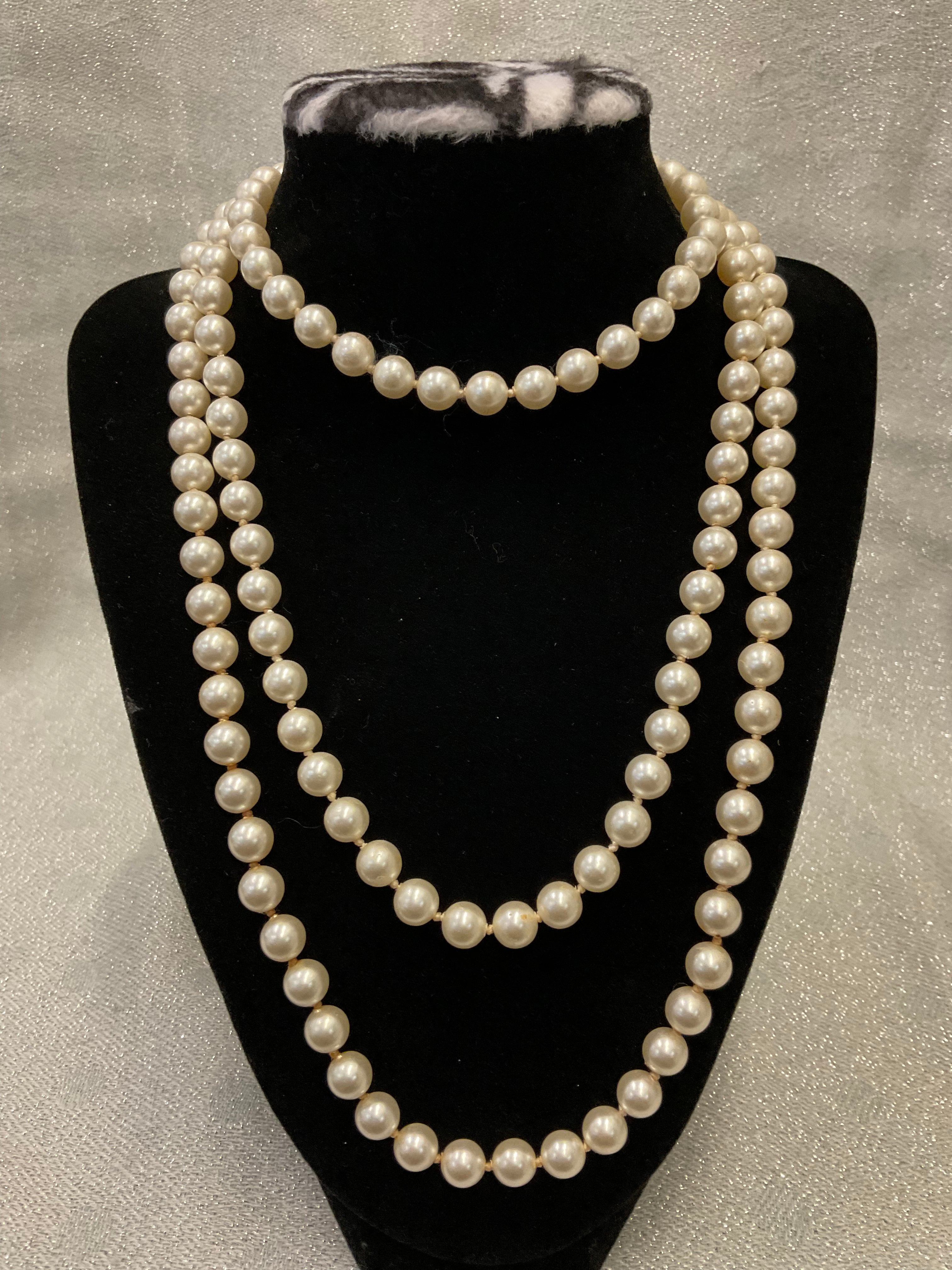 Very long one stranded pearl necklace with unique silver clasp