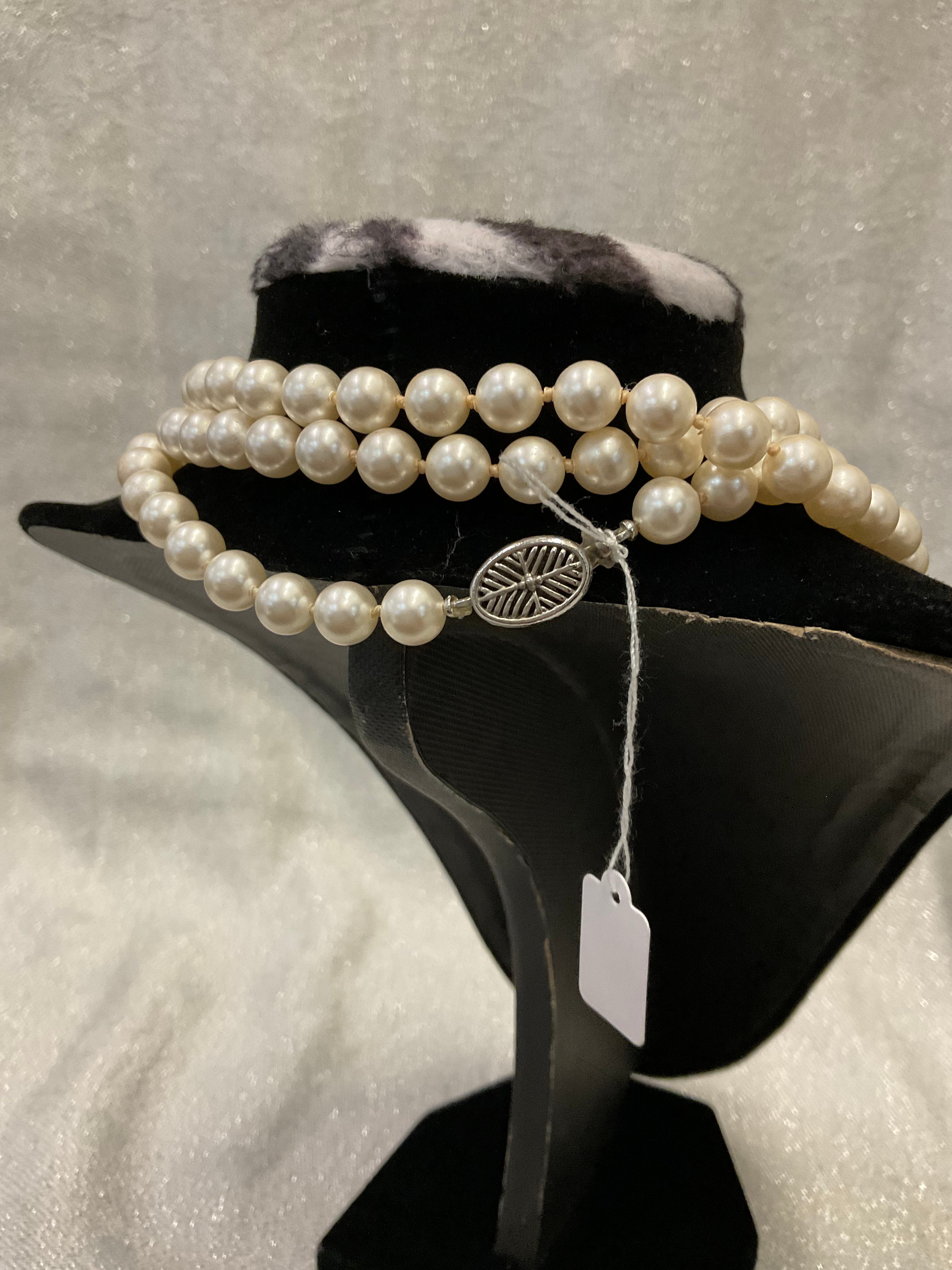 Very long one stranded pearl necklace with unique silver clasp