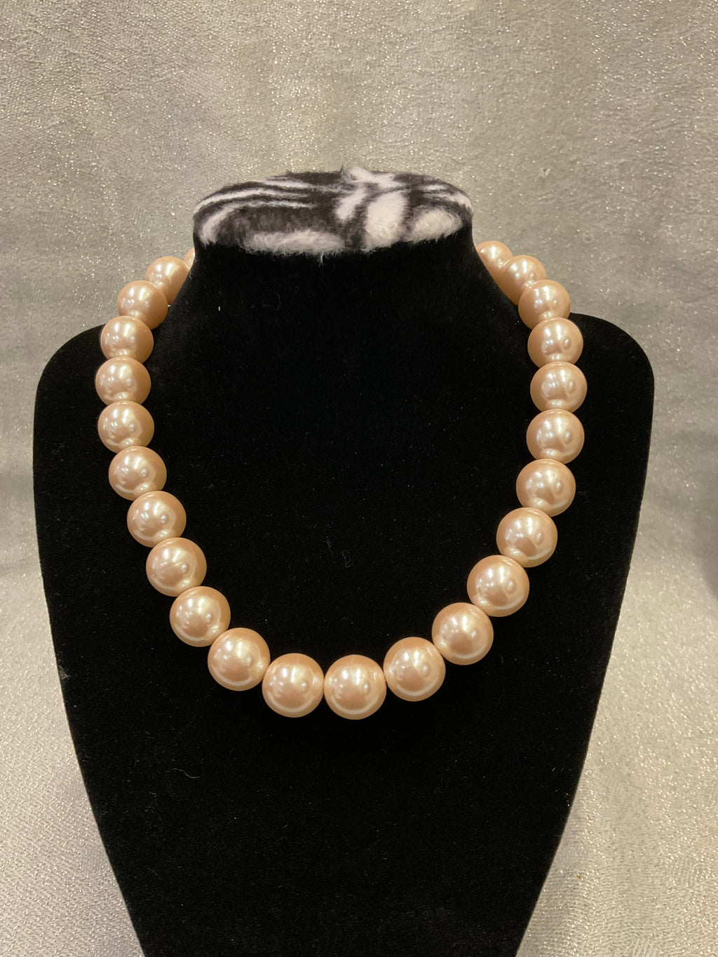 Pearl necklace with large decorative clasp