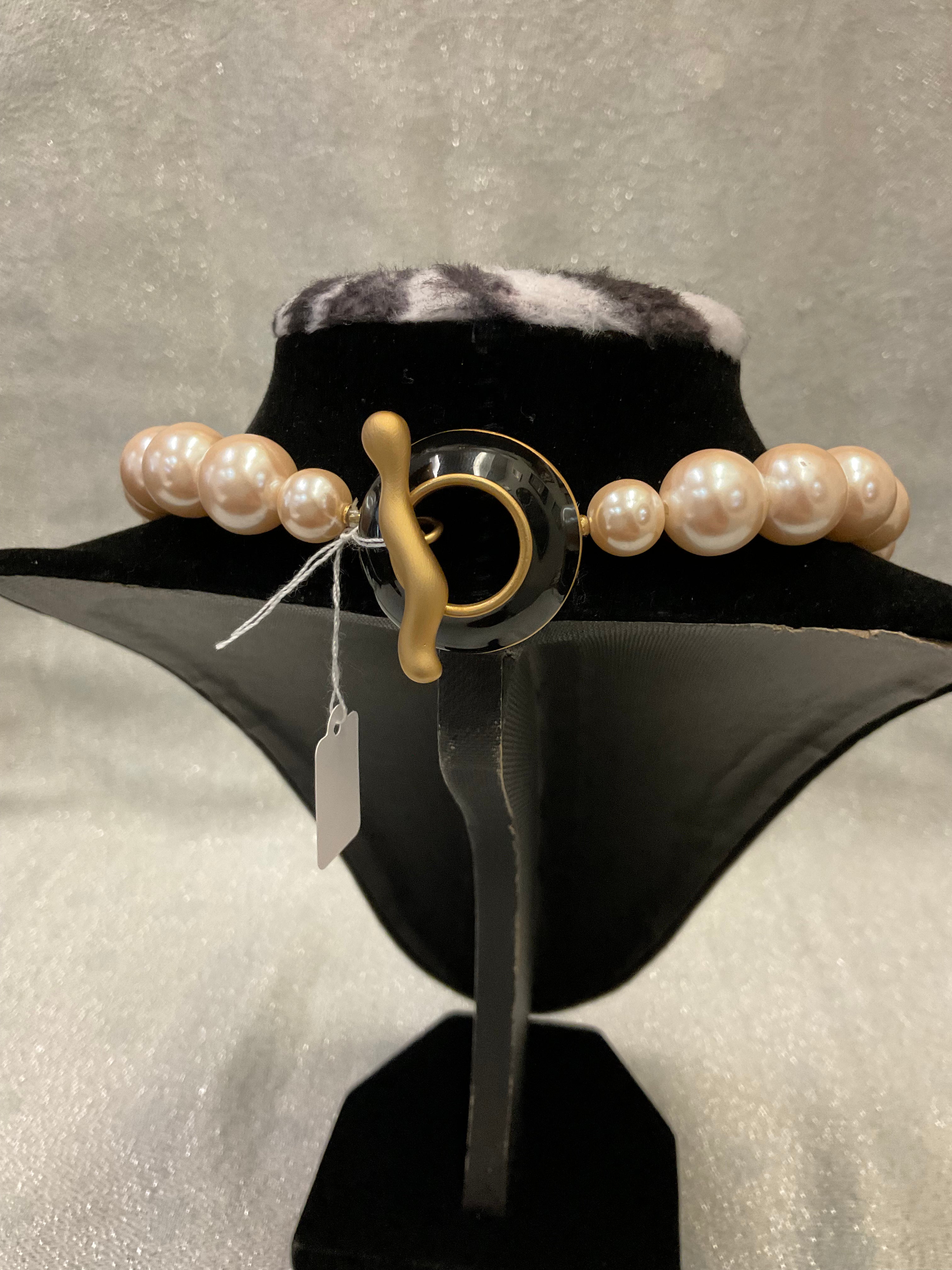 Pearl necklace with large decorative clasp