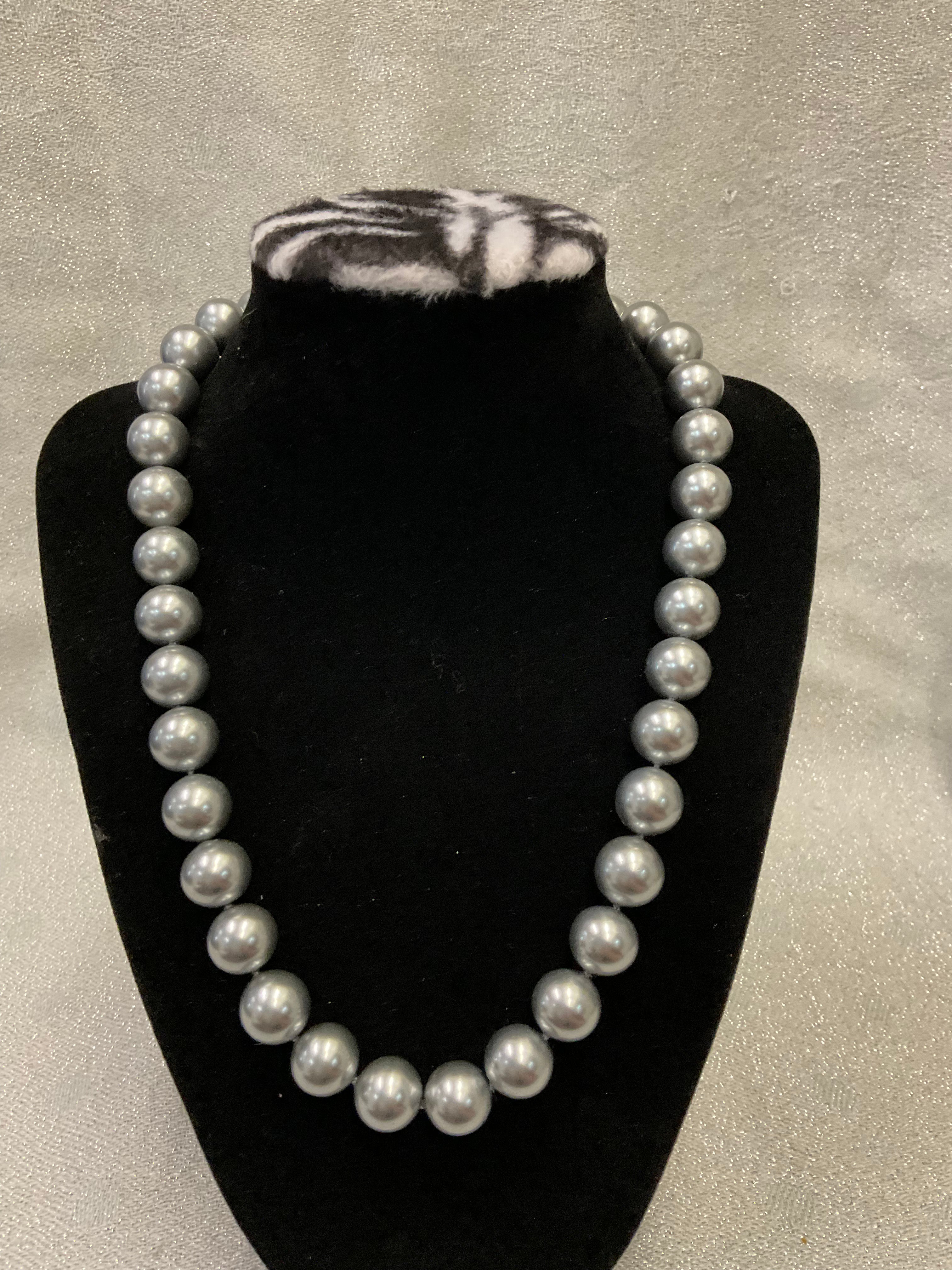 Grey pearls with decorative clasp