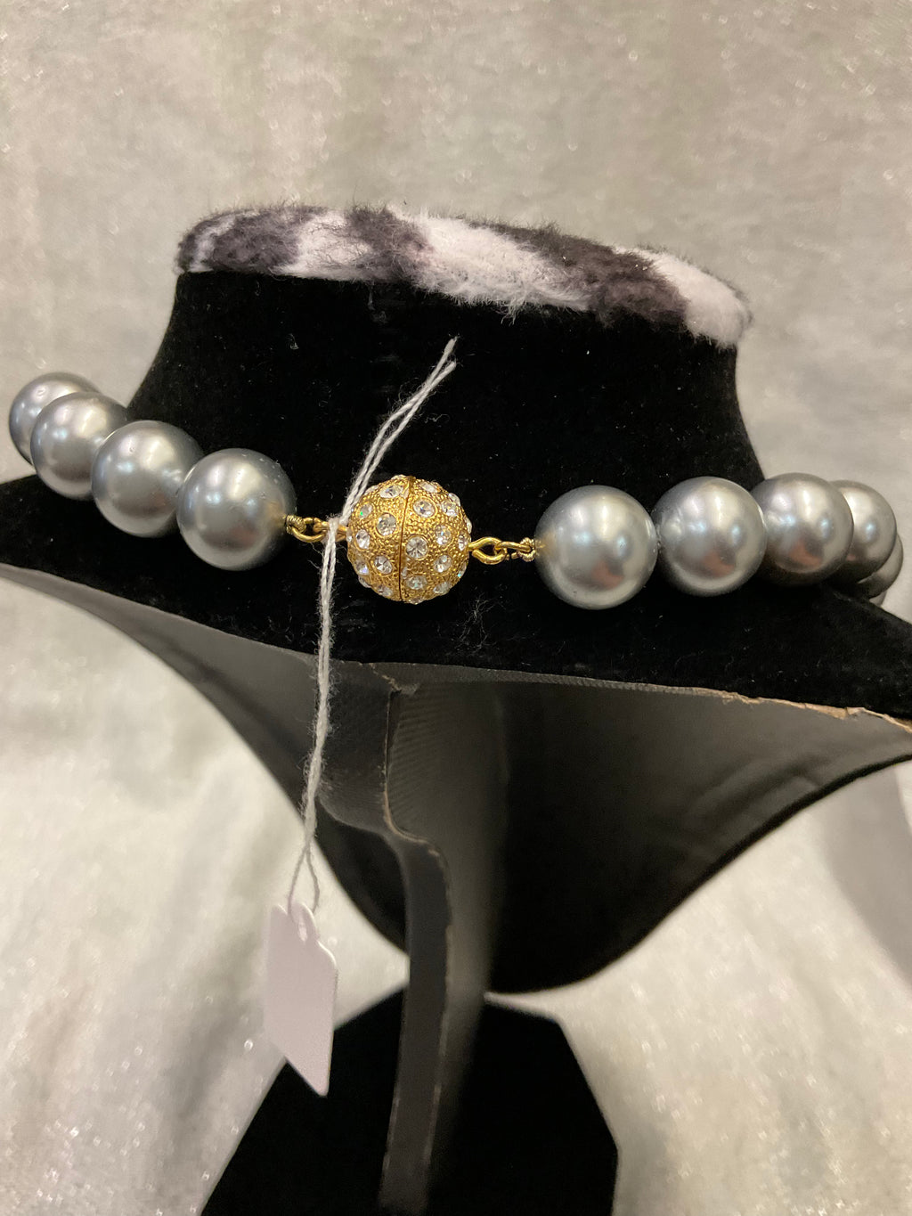 Grey pearls with decorative clasp
