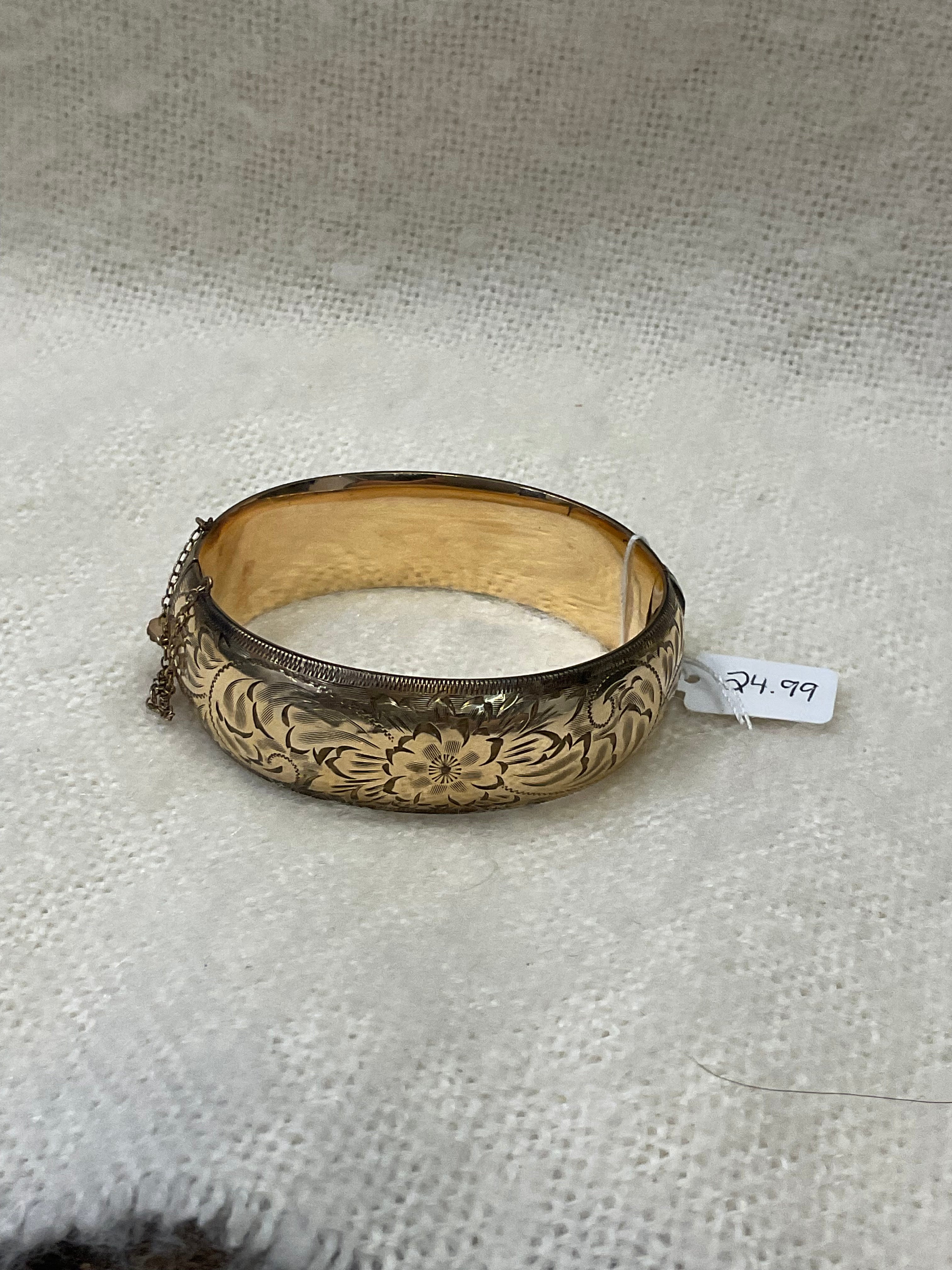 Vintage-style gold floral hinged bangle bracelet with safety chain