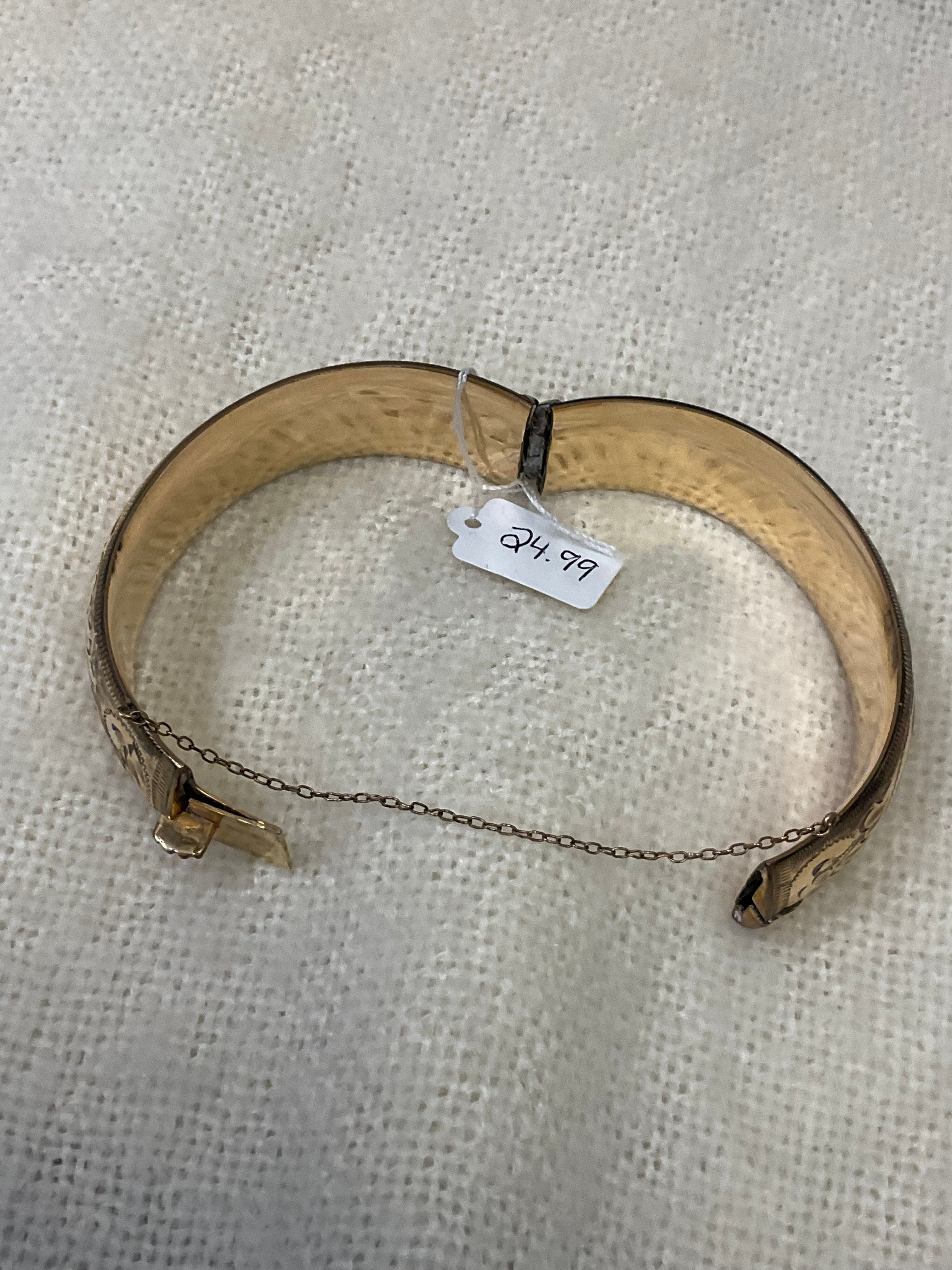 Vintage-style gold floral hinged bangle bracelet with safety chain