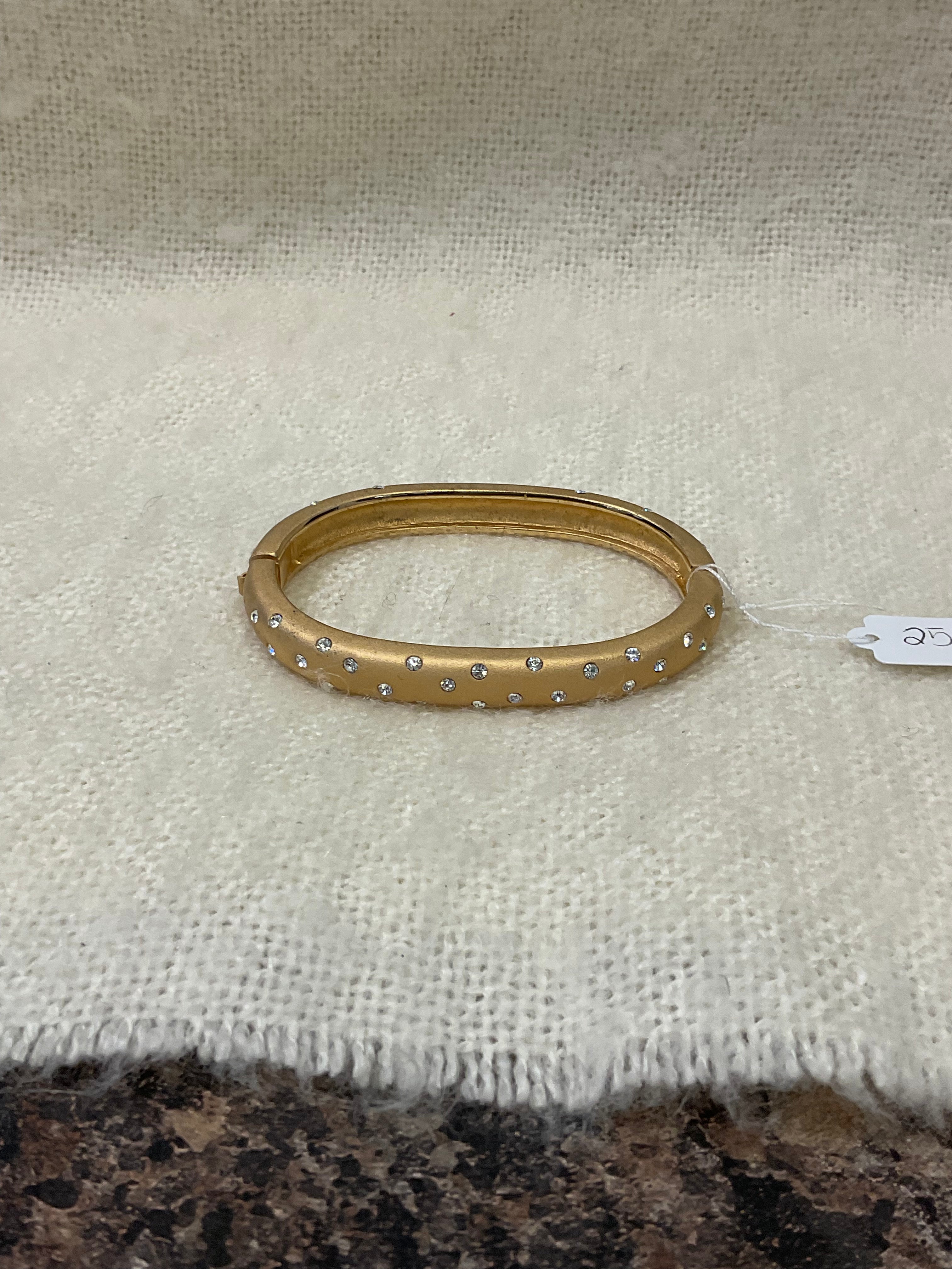 Vintage-style gold-tone hinged bracelet with sparkling rhinestone accents