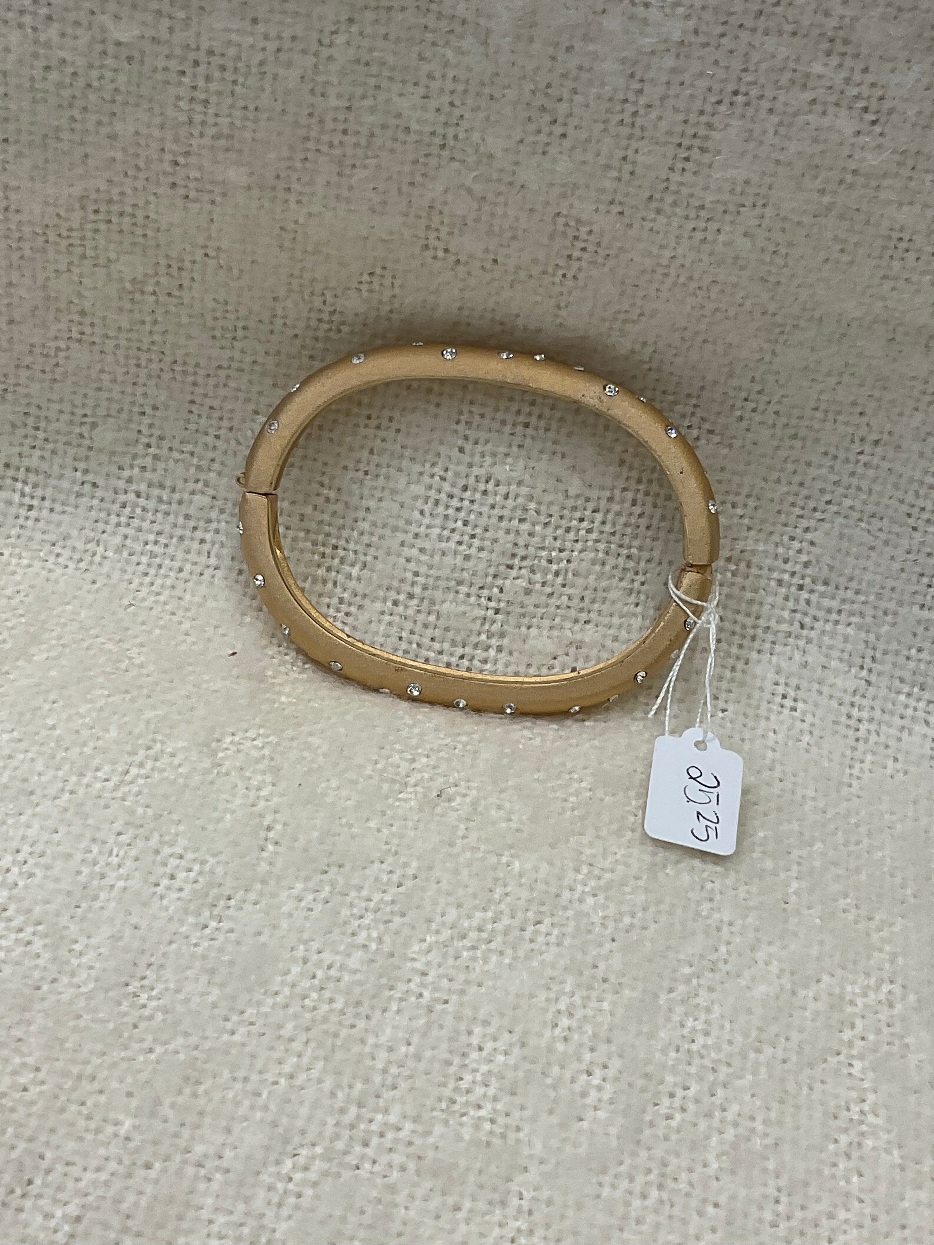 Vintage-style gold-tone hinged bracelet with sparkling rhinestone accents